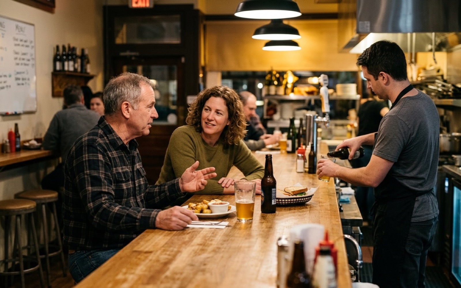 Locals at a small evening counter with drinks and small plates